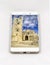 Modern smartphone displaying full screen picture of Erice Cathedral, Italy