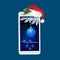 Modern smartphone with santa hat and ball, snowflakes and boughs spruce on screen/ Merry christmas greeting card.