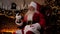 Modern smiling Santa Claus greets talks to children online smartphone video call