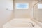 Modern soaking tub has been installed into a remodeled bathroom