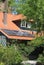 Modern solar panels at a red tiled roof, an alternative energy source,Netherlands