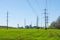 Modern soybean processing plant, agricultural Silos against green field and blue sky. Storage and drying of grains, wheat, corn,