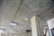 Modern square ceiling lighting and wiring installation on the ceiling and along concrete column during renovation in a new