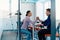 In a modern startup office, a businessman and a businesswoman business colleagues engage in a symbolic arm-wrestling