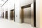 Modern steel elevator all closed cabins in a business lobby or H