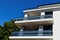 modern steel picket and glass terrace balustrade closeup. white stucco exterior wall elevation.