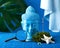 Modern still life with buddha head, palm leaves, starfish. Art concept for travel and travel agencies in blue colors.