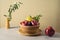 Modern still life composition with red apples, pomegranate and olive leaves