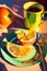 Modern still life oil painting of cup of coffee and orange slices on a green saucer. Vertical printable painting