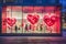 Modern storefront adorned with large red heart decorations for Valentine& x27;s Day