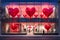 Modern storefront adorned with large red heart decorations for Valentine& x27;s Day