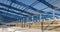 Modern storehouse construction site, the structural steel structure of a new commercial building against a clear blue