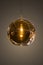 Modern streamlined mirror round copper chandelier. Bubble glass transparent pendant light. Isolate on dark background