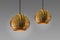 Modern streamlined mirror round copper chandelier. Bubble gold pendant light. Isolate on gray background