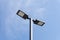 Modern street lighting against blue sky