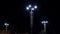 Modern street lights with garlands shine brightly at night. Stock footage. Beautiful modern design of street lights
