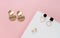 Modern stud earrings on white and pink colors background