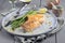 Modern style Atlantic fried salmon filet with green asparagus on a Nordic design plate