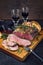 Modern style Commonwealth Sunday roast with sliced cold cuts roast beef with herbs and Yorkshire pudding on a design wooden board