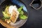 Modern style Japanese fried skrei cod fish filet with bok choi and rice in a design bowl