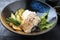 Modern style Japanese fried skrei cod fish filet with bok choi and rice in a design bowl