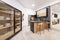 Modern style kitchen with wooden furniture combined with black, a counter with stools and a sideboard for dishes with sliding