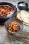 Modern style slow cooked Lebanese vegetarian eggplant stew maghmour with chickpeas and pita bread in a rustic design bowl