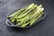 Modern style traditional barbecued green asparagus with herbs on a design plate