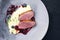 Modern style traditional gourmet duck breast filet with mashed potatoes and cranberry sauce on a design plate