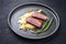 Modern style traditional gourmet duck breast filet with mashed potatoes and orange sauce on a modern Nordic design plate