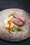 Modern style traditional gourmet duck breast filet with mashed potatoes and orange sauce on a rustic design plate