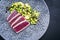 Modern style traditional Japanese gourmet seared tuna fish steak tataki with avocado fruit and edamame soy beans