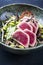 Modern style traditional Japanese gourmet seared tuna fish steak tataki with soba noodles and stir-fried vegetables