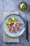 Modern style traditional Japanese tuna tataki with vegetable and wakame on a design plate