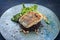 Modern style traditional pan-fried skrei cod fish filet in breadcrumbs with baby broccoli, black rice and portulaca lettuce
