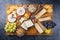 Modern style traditional party platter with soft cheese, fruits and snacks on a wooden design board