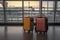 Modern stylish suitcases standing in empty airport hall, unrecognizable traveller\\\'s luggage