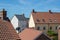 Modern suburban crowded housing estate buildings. Urban house roof tops