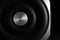 Modern subwoofer on black background, closeup. Powerful audio speaker