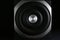 Modern subwoofer on black background  closeup. Powerful audio speaker