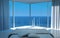 Modern sunny bedroom interior with fantastic seascape view
