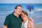 Modern sweet and loving hispanic mature couple taking selfie portrait- senior retired husband and wife on their 70s enjoying beach