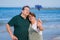 Modern sweet and loving hispanic mature couple taking selfie portrait- senior retired husband and wife on their 70s enjoying beach