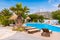 Modern swimming pool with sunbeds at Medusa resort on the Plaka beach. Naxos island