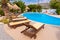 Modern swimming pool with sunbeds at Medusa resort on the Plaka beach. Naxos island