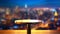 Modern table against dreamy bokeh of night cityscape.
