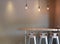 Modern table counter bar with chairs loft interior with gray tile wall and hanging decor lamps