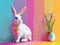 Modern take on Easter bunny and Easter eggs. Polygonal bunny, bright colors. Happy Easter background