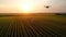 Modern technologies in agriculture. Industrial drone flies over a green field and sprays