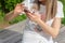 Modern Technology in Nature: Young Woman Engaging with Smartphone on a Sunny Spring Da